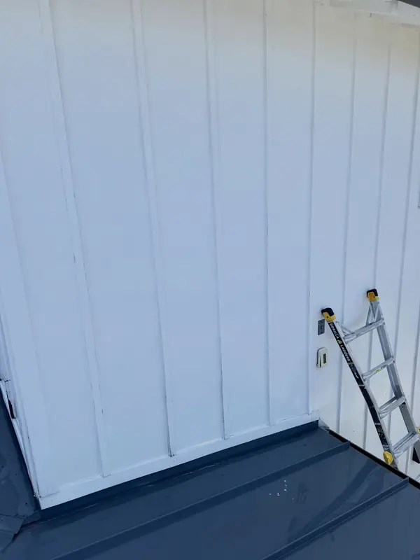 The same siding bright white after a soft wash